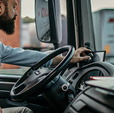 A man confident, and proud of his career. professional truck driver using the radio to communicate and talk.