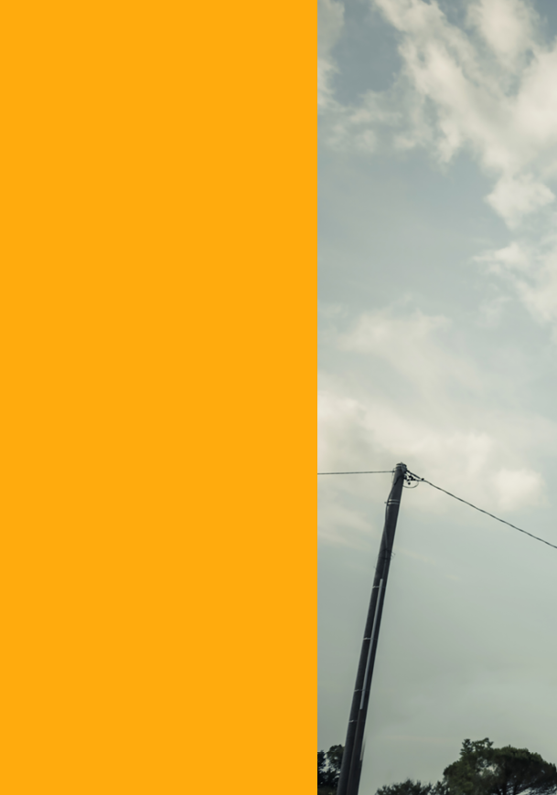 A tall utility pole with wires extending from it stands against a cloudy sky with some trees visible at the bottom. Description generated by AI